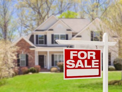 Home For Sale Real Estate Sign and Beautiful New House.